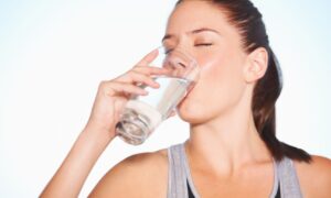 Donna che beve un bicchiere d'acqua